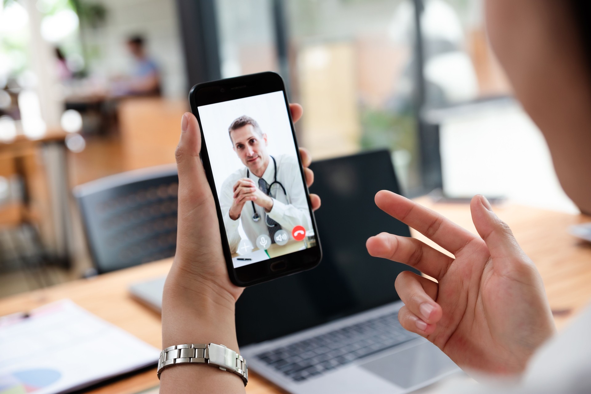 Businesswoman talking with doctor online from office.