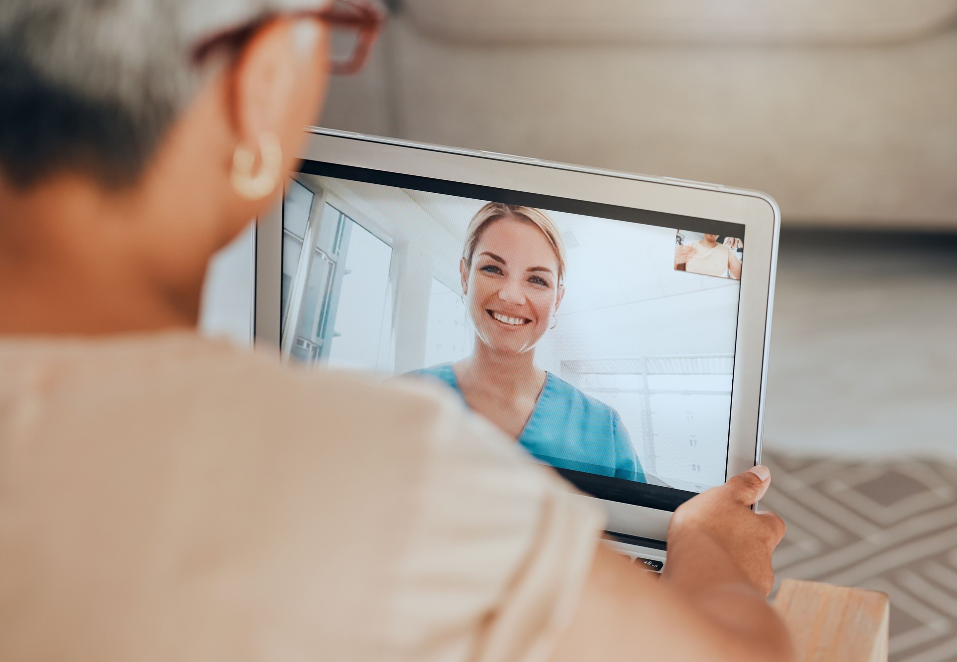 Telehealth, covid and tablet with doctor and patient for consulting, checkup or conversation for health, advice or talk. Healthcare, medical professional or senior woman video call, help or in lounge