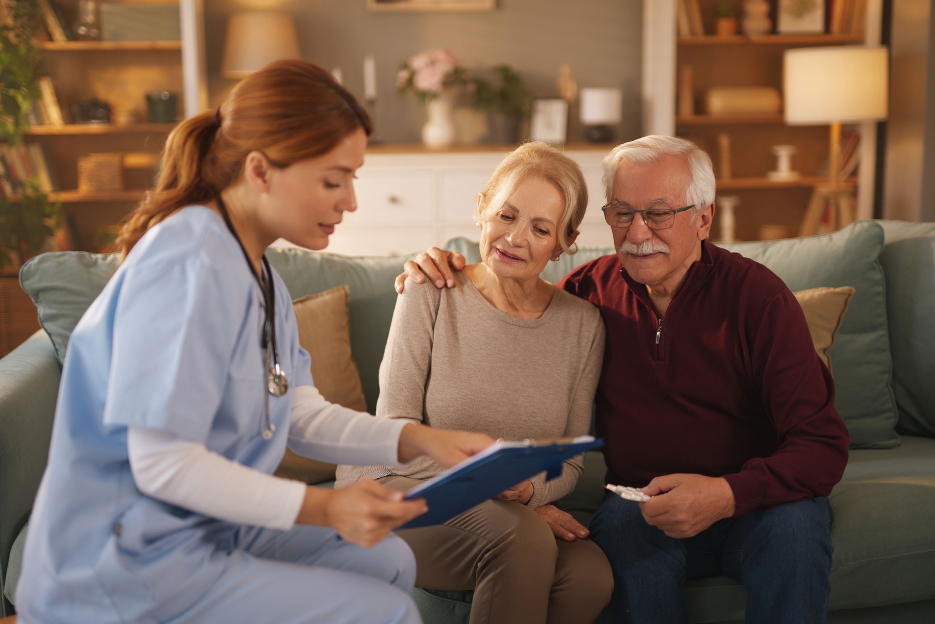 Home nurse assisting senior couple with medical information